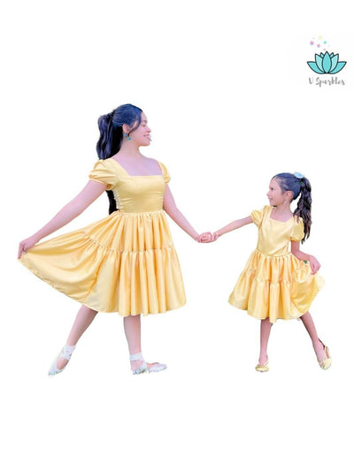 Base Yellow Twirl Dress for Adults – Ideal for Disneybounding and Holiday Celebrations – This Princess Tiana-inspired yellow twirl dress is perfect for creating an elegant Disneybounding look for adults at holiday events or themed celebrations. Available in mid-size and plus-size options.